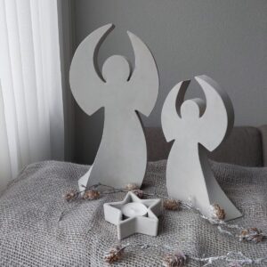 Weisser Betonengel in gerundeter Form mit Stern Kerzenhalter auf dekorativer Unterlage